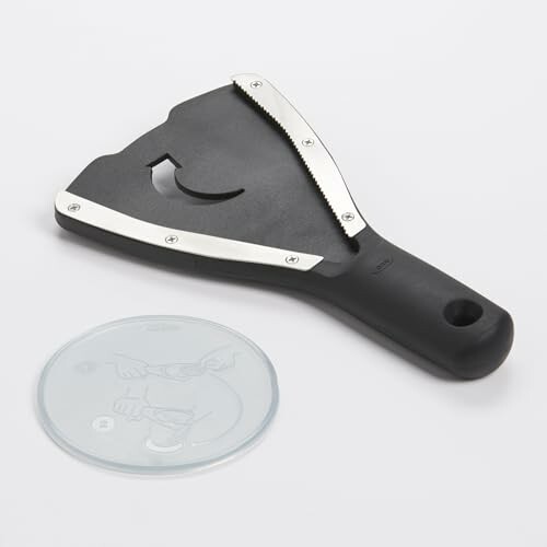 Black kitchen slicer with a serrated edge and a protective cover.
