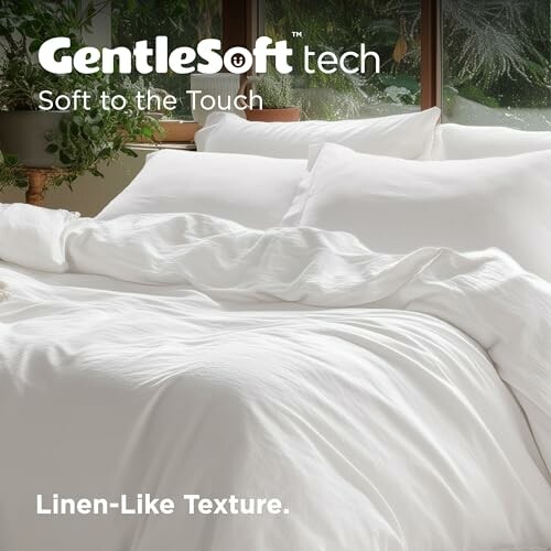 White bedding with GentleSoft technology, soft to the touch, in a cozy room.