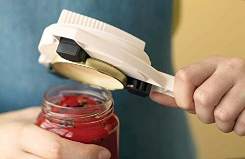Person using a jar opener tool on a jar.